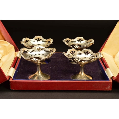 204 - A CASED SET OF FOUR GEORGE V SILVER PEDESTAL BON BON DISHES, foliate embossed wavy rims above pierce... 