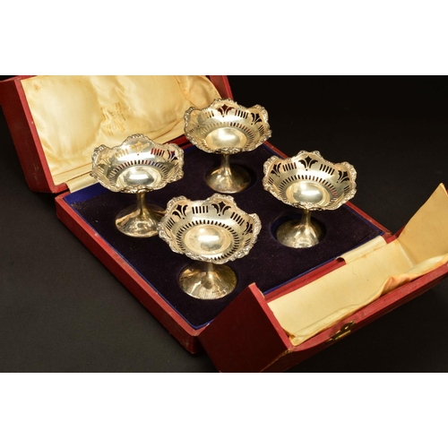 204 - A CASED SET OF FOUR GEORGE V SILVER PEDESTAL BON BON DISHES, foliate embossed wavy rims above pierce... 