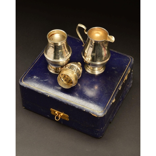 205 - A GEORGE V CASED SILVER MAPPIN & WEBB SILVER CREAM JUG AND SUGAR CASTER, both of girdled baluster fo... 