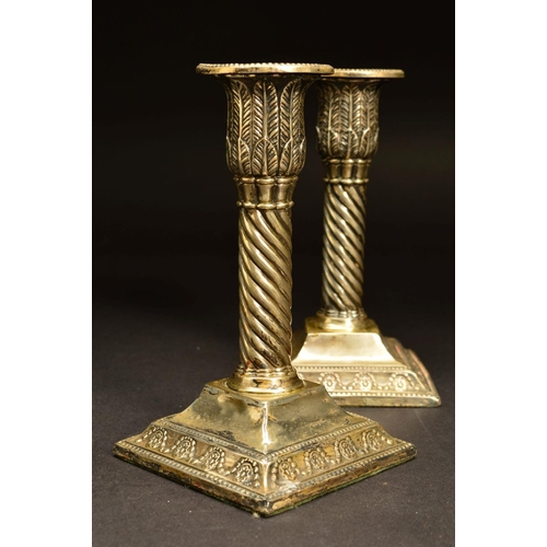 209 - A PAIR OF EDWARDIAN SILVER DWARF CANDLESTICKS, the removable sconces with beaded rims above foliate ... 