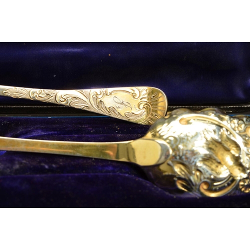 210 - A CASED PAIR OF GEORGE IV SILVER GILT BERRY SPOONS, foliate chased handles engraved with initials 'J... 