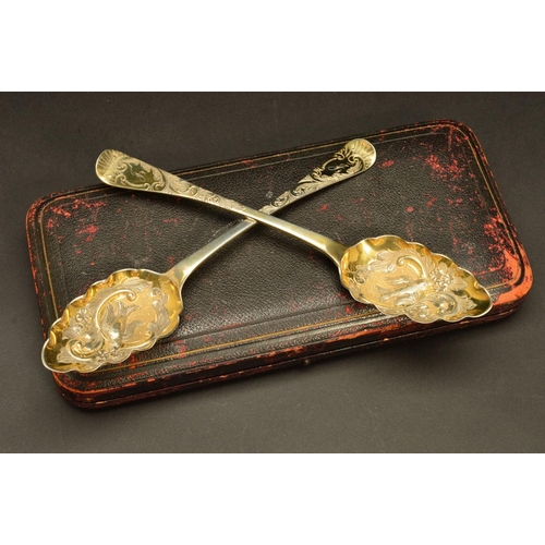 210 - A CASED PAIR OF GEORGE IV SILVER GILT BERRY SPOONS, foliate chased handles engraved with initials 'J... 