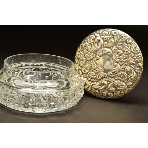 223 - AN ELIZABETH II SILVER TOPPED GLASS DRESSING TABLE/POWDER BOWL, of circular form, foliate repousse d... 