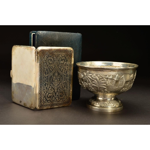 228 - AN INDIAN SILVER PEDESTAL BOWL, embossed with a continuous scene of village life with buildings, cat... 