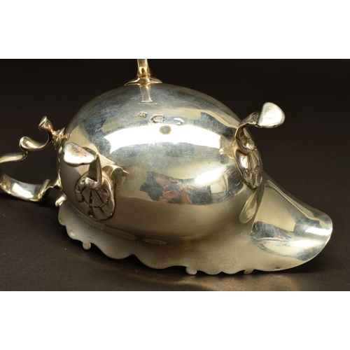 230 - A GEORGE II SILVER SAUCEBOAT, wavy rim, 'S' scroll handle, on three cabriole legs, shell knees and f... 