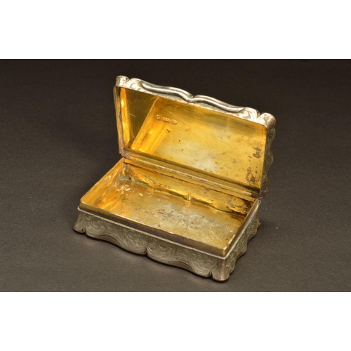 232 - A VICTORIAN SILVER SNUFF BOX, of shaped rectangular form, foliate engraved decoration throughout wit... 