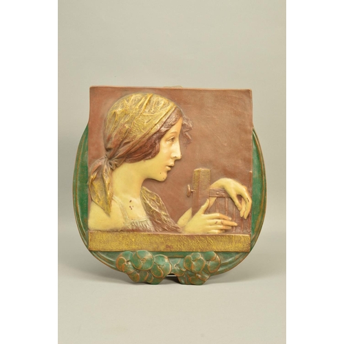 293 - AN EARLY 20TH CENTURY ERNST WAHLISS ART NOUVEAU POTTERY PLAQUE, moulded in relief with a portrait of... 