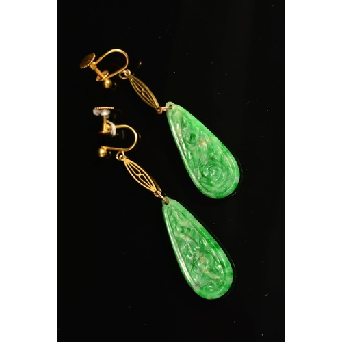 32 - AN EARLY 20TH CENTURY PAIR OF CARVED JADE DROP EARRINGS, each pear shaped jadite carved in a floral ... 