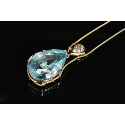 4 - A MODERN 18CT WHITE GOLD LARGE BLUE TOPAZ AND DIAMOND PENDANT, claw set in an abstract mount, topaz ... 