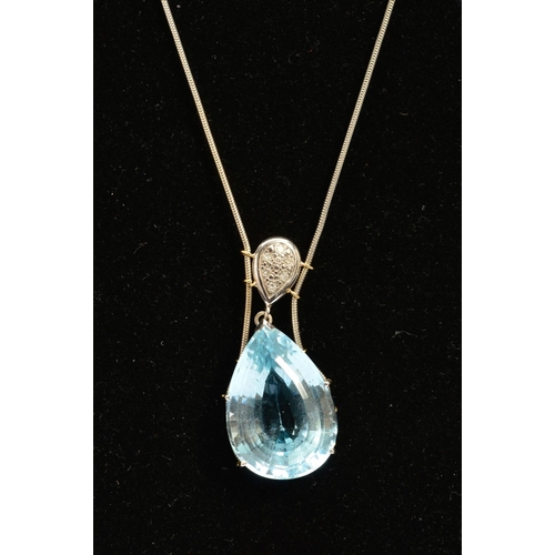 4 - A MODERN 18CT WHITE GOLD LARGE BLUE TOPAZ AND DIAMOND PENDANT, claw set in an abstract mount, topaz ... 