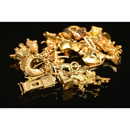 53 - A 9CT GOLD CHARM BRACELET, the fancy link bracelet suspending a total of thirty charms, to include a... 