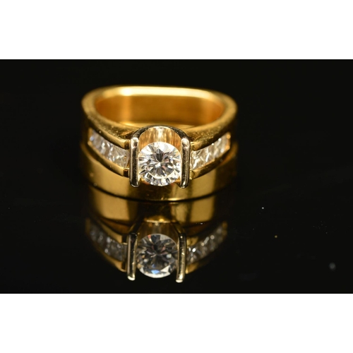 56 - TWO RINGS, the first an abstract design diamond ring, centring on a principle modern round brilliant... 