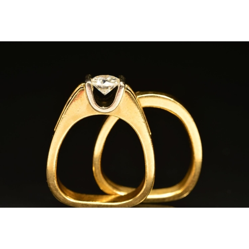 56 - TWO RINGS, the first an abstract design diamond ring, centring on a principle modern round brilliant... 