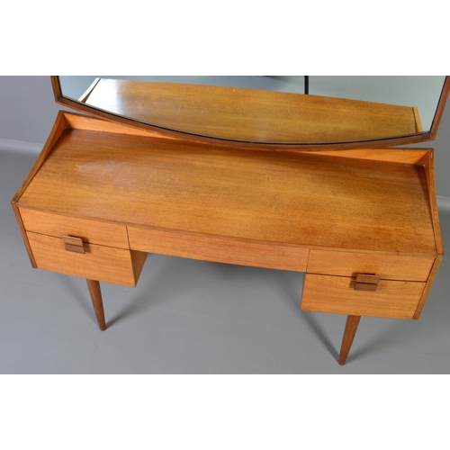 589 - IB KOFOD LARSEN, FOR GPLAN DANISH RANGE, a teak 1960s dressing table, with a shaped mirror above on... 