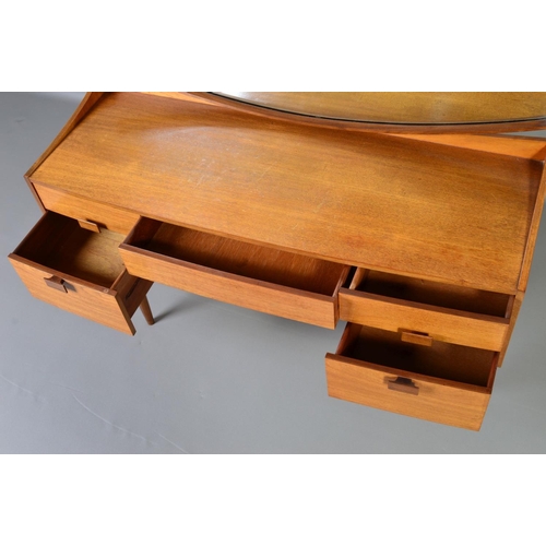 589 - IB KOFOD LARSEN, FOR GPLAN DANISH RANGE, a teak 1960s dressing table, with a shaped mirror above on... 