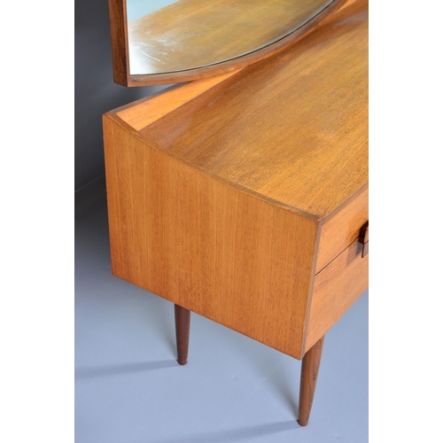 589 - IB KOFOD LARSEN, FOR GPLAN DANISH RANGE, a teak 1960s dressing table, with a shaped mirror above on... 