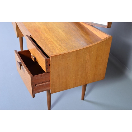 589 - IB KOFOD LARSEN, FOR GPLAN DANISH RANGE, a teak 1960s dressing table, with a shaped mirror above on... 