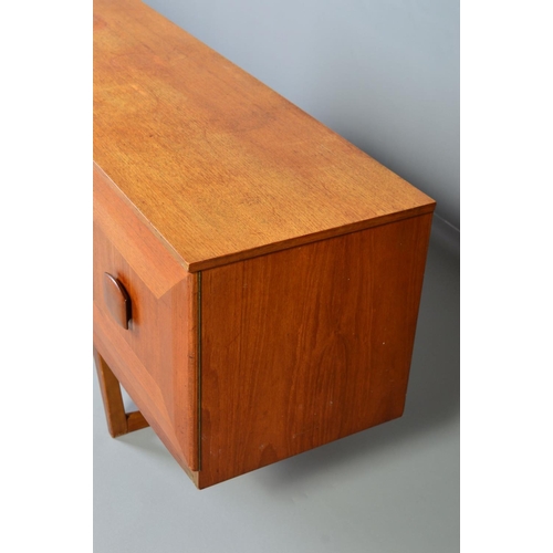 598 - A STONEHILL TEAK SIDEBOARD, the door fronts with a geometric pattern and central shaped handle, flan... 