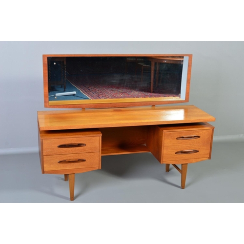 599 - A GPLAN STYLE DRESSING TABLE, with a rectangular mirror, above flanked by two drawers to each side o... 