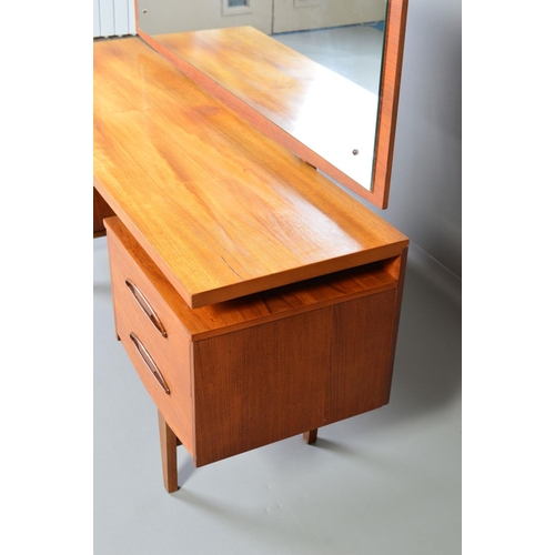 599 - A GPLAN STYLE DRESSING TABLE, with a rectangular mirror, above flanked by two drawers to each side o... 