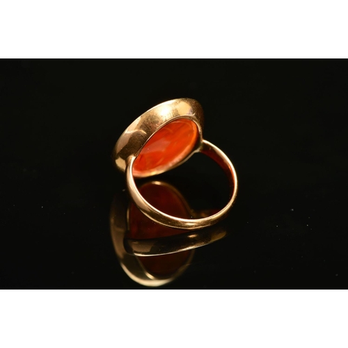 60 - A CARNELIAN INTAGLIO RING, the oval carnelian carved to depict a bearded man, within a collet mount ... 