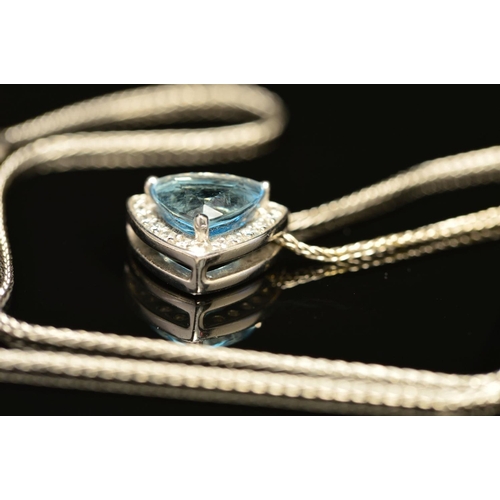 64 - A MODERN 18CT WHITE GOLD AQUAMARINE AND DIAMOND TRIANGULAR SHAPE PENDANT, centring on a principle tr... 