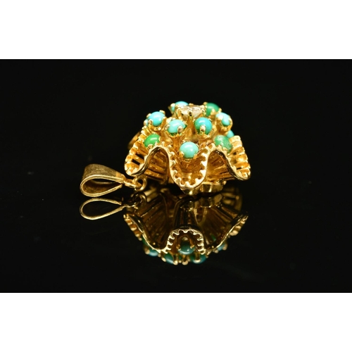 65 - A TURQUOISE AND DIAMOND PENDANT, the floral like undulating outline with tiered spokes claw set with... 