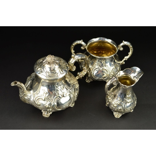 86 - A VICTORIAN SILVER THREE PIECE TEASET, of baluster form, the teapot with flower head finial, ivory i... 