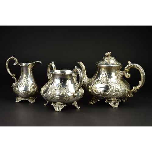 86 - A VICTORIAN SILVER THREE PIECE TEASET, of baluster form, the teapot with flower head finial, ivory i... 