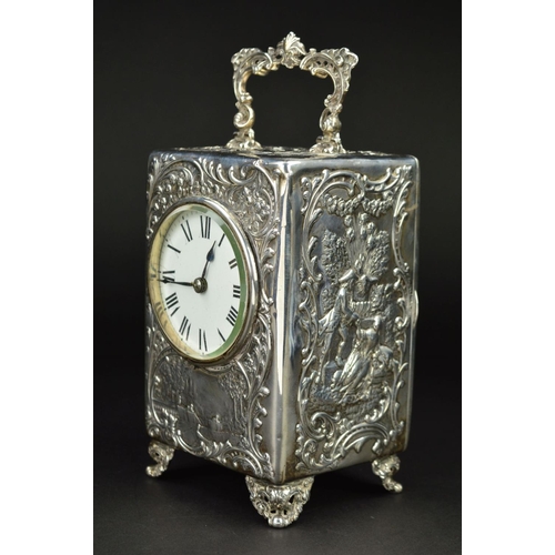 87 - AN EDWARDIAN SILVER CASED BOUDOIR OR CARRIAGE TIMEPIECE, the top with hinged carrying handle cast an... 