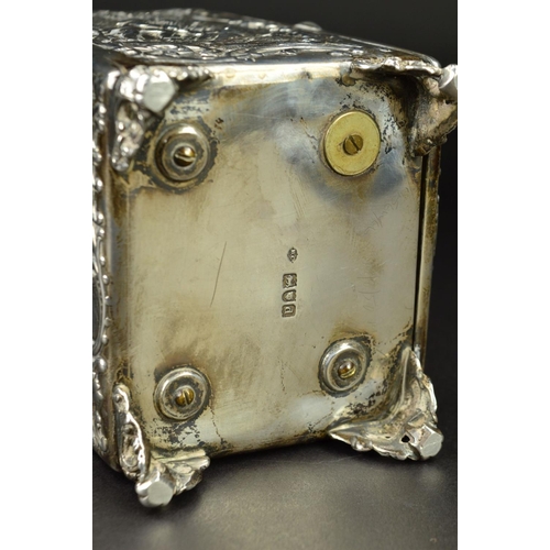 87 - AN EDWARDIAN SILVER CASED BOUDOIR OR CARRIAGE TIMEPIECE, the top with hinged carrying handle cast an... 