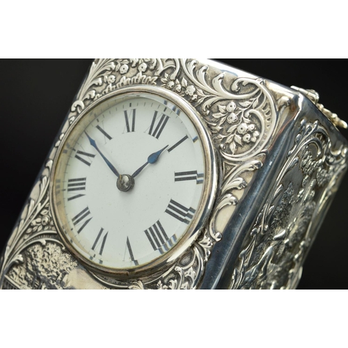 87 - AN EDWARDIAN SILVER CASED BOUDOIR OR CARRIAGE TIMEPIECE, the top with hinged carrying handle cast an... 