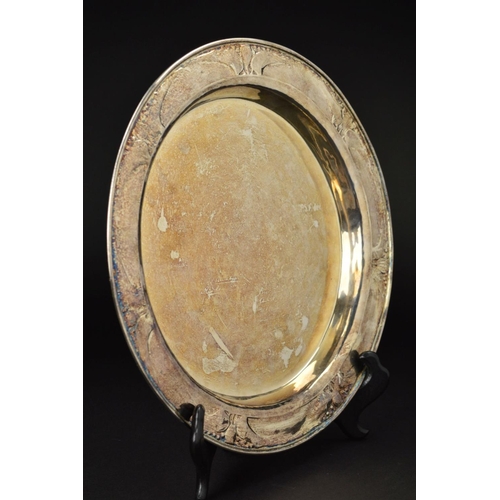 88 - AN EDWARDIAN GUILD OF HANDICRAFTS SILVER TRAY, of circular form, the rim with a border of embossed s... 