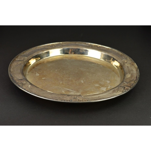 88 - AN EDWARDIAN GUILD OF HANDICRAFTS SILVER TRAY, of circular form, the rim with a border of embossed s... 