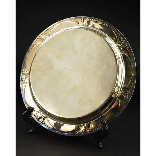 88 - AN EDWARDIAN GUILD OF HANDICRAFTS SILVER TRAY, of circular form, the rim with a border of embossed s... 