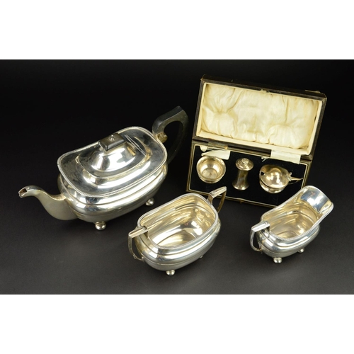 89 - A GEORGE V SILVER THREE PIECE TEASET, of shaped rectangular form, gadrooned rims, ebonised fitments,... 