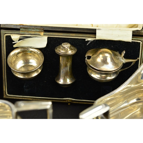 89 - A GEORGE V SILVER THREE PIECE TEASET, of shaped rectangular form, gadrooned rims, ebonised fitments,... 