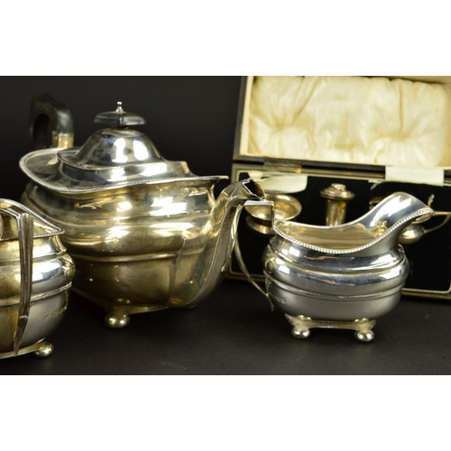 89 - A GEORGE V SILVER THREE PIECE TEASET, of shaped rectangular form, gadrooned rims, ebonised fitments,... 