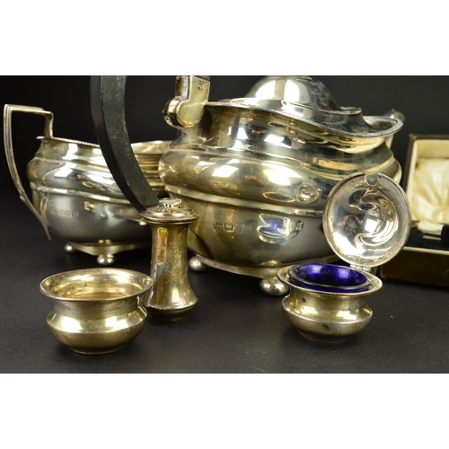 89 - A GEORGE V SILVER THREE PIECE TEASET, of shaped rectangular form, gadrooned rims, ebonised fitments,... 