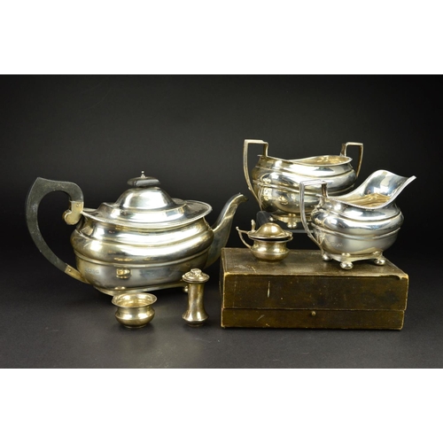 89 - A GEORGE V SILVER THREE PIECE TEASET, of shaped rectangular form, gadrooned rims, ebonised fitments,... 