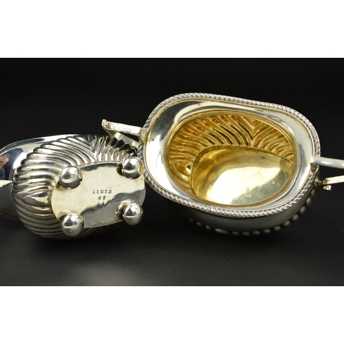 98 - AN EDWARDIAN SILVER OVAL CREAM JUG AND SUGAR BOWL, gadrooned rims and part reeded bodies, on flatten... 