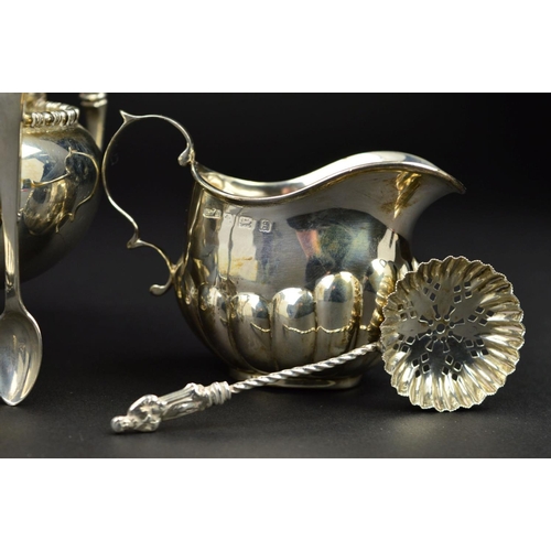 99 - A GEORGE V SILVER TWIN HANDLED SUGAR BOWL, of circular form, cast bobbin rims, 'C' scroll handles, m... 