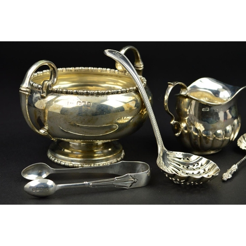 99 - A GEORGE V SILVER TWIN HANDLED SUGAR BOWL, of circular form, cast bobbin rims, 'C' scroll handles, m... 