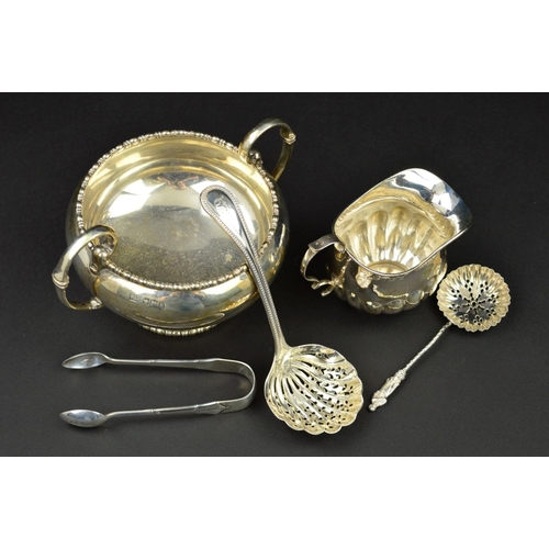 99 - A GEORGE V SILVER TWIN HANDLED SUGAR BOWL, of circular form, cast bobbin rims, 'C' scroll handles, m... 