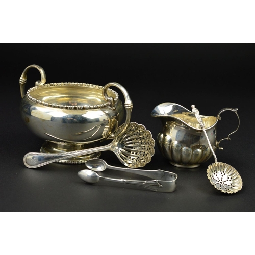 99 - A GEORGE V SILVER TWIN HANDLED SUGAR BOWL, of circular form, cast bobbin rims, 'C' scroll handles, m... 