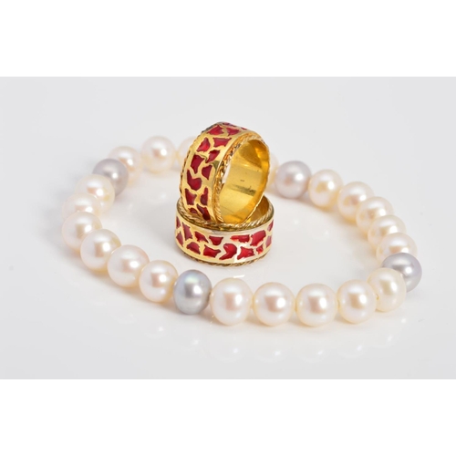 63 - TWO MODERN SILVER GILT RED ENAMEL BAND RINGS and a freshwater grey and white elastic bracelet, each ... 