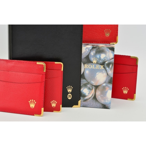 103 - A COLLECTION OF ROLEX ACCESSORIES, black note pad, four red Rolex card sleeves and a pearl design Ro... 