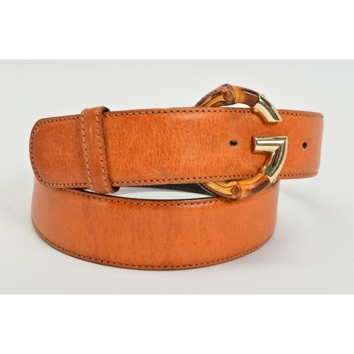 111 - A GUCCI LEATHER BELT WITH BAMBOO BUCKLE, the belt of tan leather with a G motif buckle in gold tone ... 