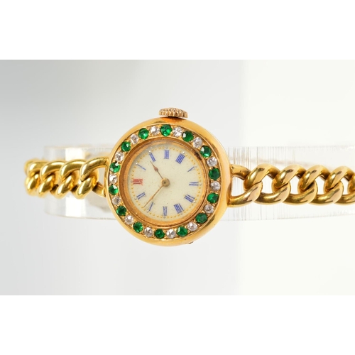 93 - AN EARLY 20TH CENTURY GOLD EMERALD AND DIAMOND WATCH, round case measuring approximately 25.0mm in d... 