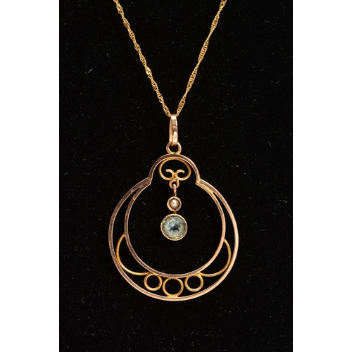 106 - AN EDWARDIAN 9CT GOLD AQUAMARINE AND SPLIT PEARL OPENWORK PENDANT AND LATER CHAIN, the pendant of ci... 